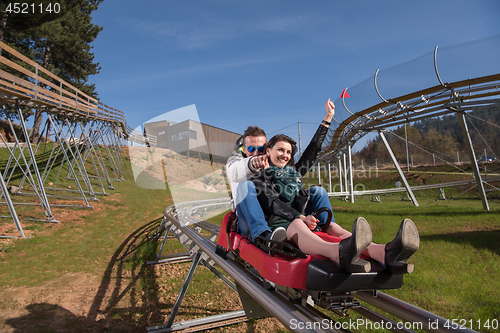 Image of couple enjoys driving on alpine coaster