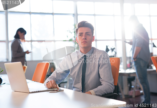 Image of businessman working using a laptop in startup office