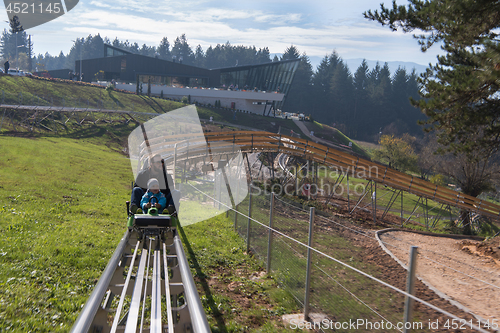 Image of father and son enjoys driving on alpine coaster