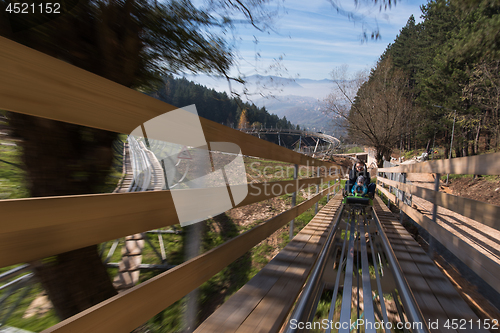 Image of father and son enjoys driving on alpine coaster