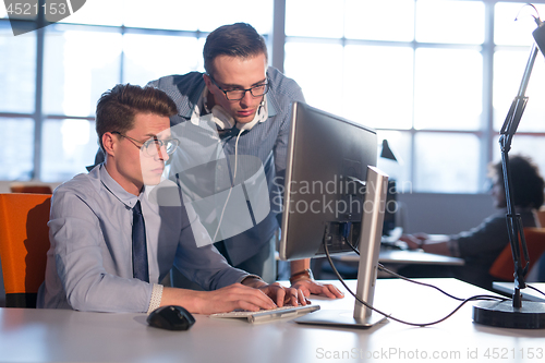 Image of Two Business People Working With computer in office