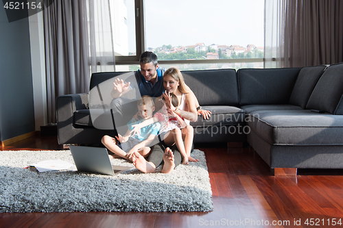 Image of Family Playing Together with laptop computer