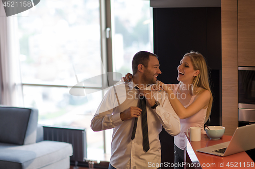 Image of A young couple is preparing for a job and using a laptop