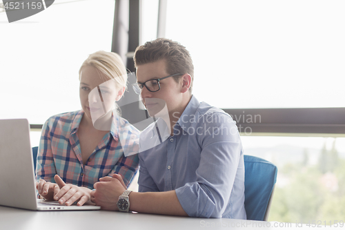 Image of Two Business People Working With laptop in office