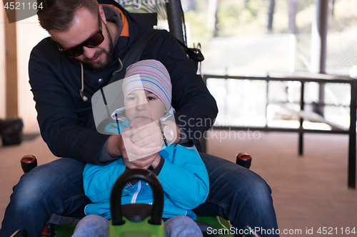 Image of father and son enjoys driving on alpine coaster