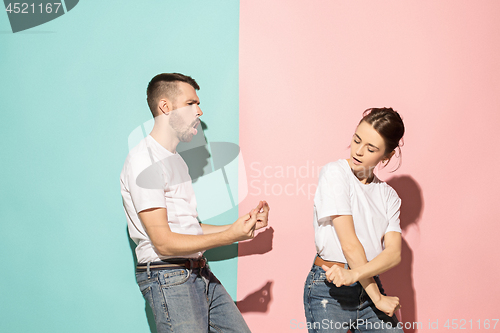 Image of A couple of young man and woman dancing hip-hop at studio.