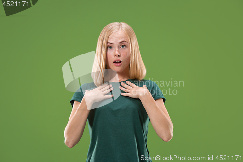 Image of Beautiful woman looking suprised isolated on green