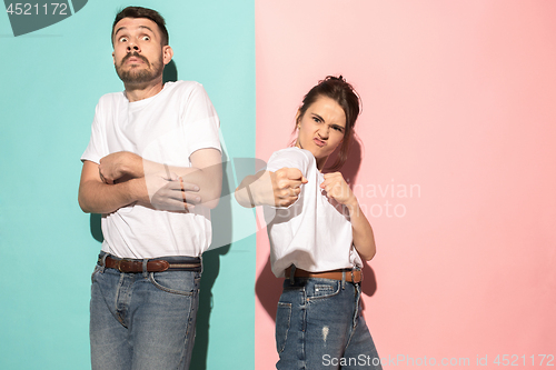 Image of The young emotional angry woman on pink studio background