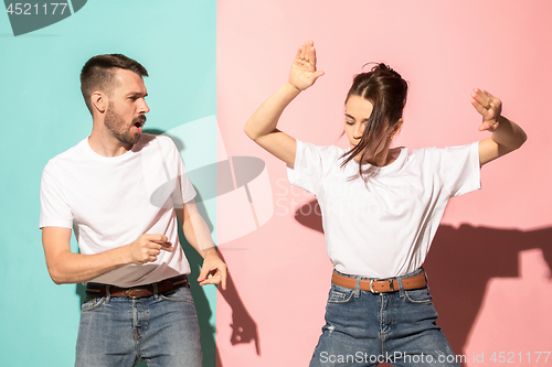 Image of A couple of young man and woman dancing hip-hop at studio.