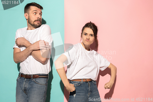 Image of The young emotional angry woman on pink studio background