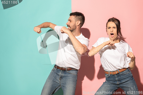 Image of A couple of young man and woman dancing hip-hop at studio.