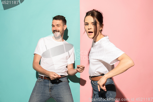 Image of A couple of young man and woman dancing hip-hop at studio.