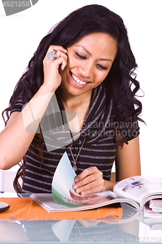 Image of Beautiful Woman Reading a Magazine