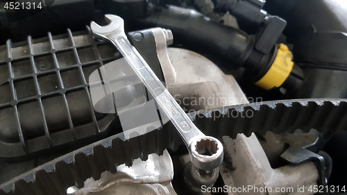 Image of Spanner and timing belt on car engine