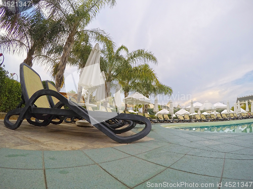 Image of Summer resort: chaise longue near swimming pool