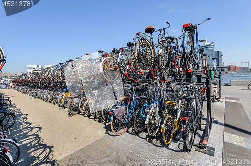 Image of AMSTERDAM, HOLLAND - AUGUST 01: Amsterdam Central station. Many bicycles parked in front of the Central station on August 01, 2012 in Amsterdam, Holland.