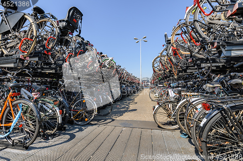 Image of AMSTERDAM, HOLLAND - AUGUST 01: Amsterdam Central station. Many bicycles parked in front of the Central station on August 01, 2012 in Amsterdam, Holland.