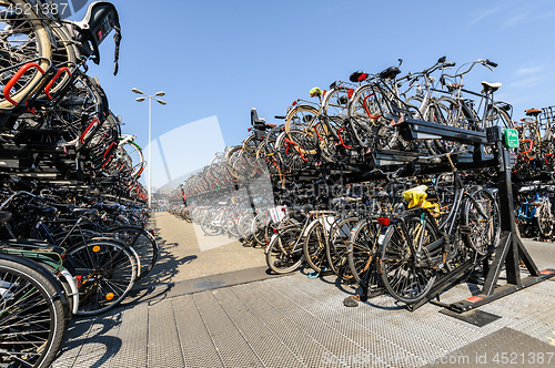 Image of AMSTERDAM, HOLLAND - AUGUST 01: Amsterdam Central station. Many bicycles parked in front of the Central station on August 01, 2012 in Amsterdam, Holland.