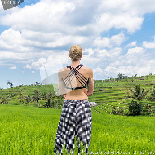 Image of Relaxed casual sporty woman enjoying pure nature at beautiful green rice fields on Bali.