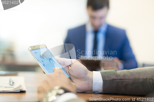 Image of Close up of businessman using mobile smart phone.