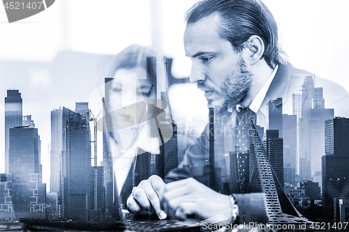 Image of Business people in modern office against new york city manhattan buildings and skyscrapers window reflections.