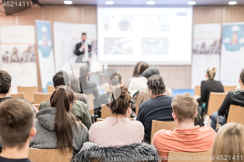 Image of Man giving presentation in lecture hall at university.