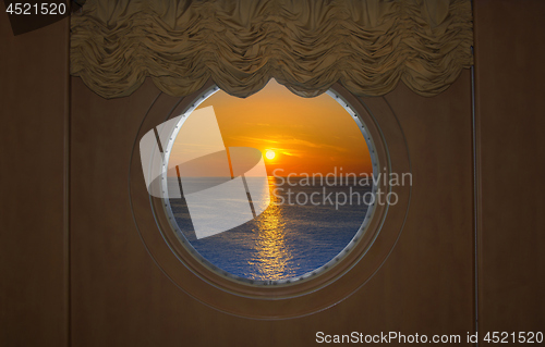 Image of Beautiful Sunset Seen Through a round Ship Porthole