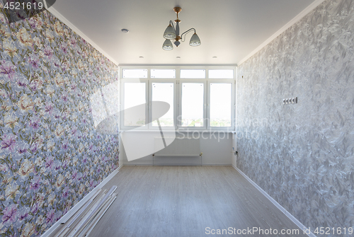 Image of Empty room in the apartment after repair, with different wallpaper, with a large wide window