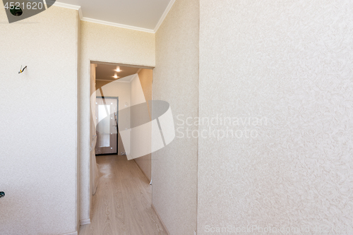 Image of A long corridor in the apartment, going from the kitchen to the exit