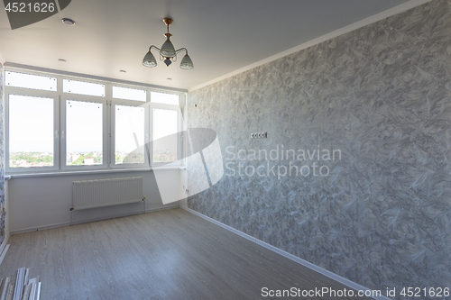 Image of Empty room in the apartment after repair, with a large wide window