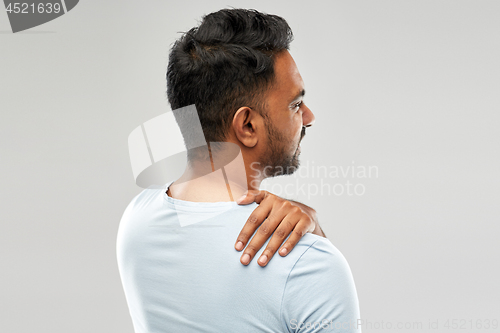 Image of unhealthy indian man suffering from neck pain