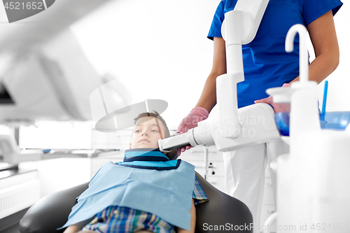 Image of dentist making x-ray of kid teeth at dental clinic