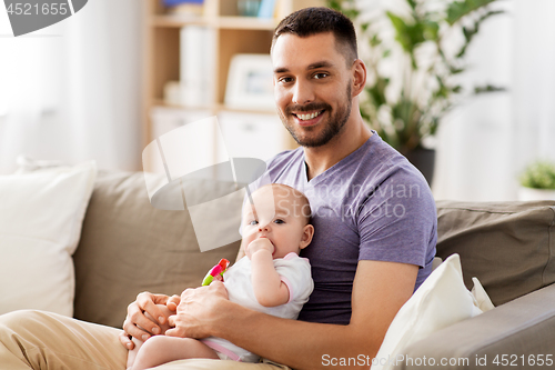 Image of happy father with little baby daughter at home