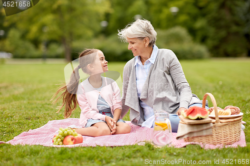 Image of grandmother and granddaughter at picnic in park