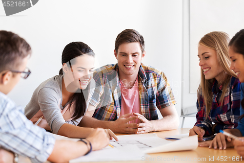 Image of group of smiling students with blueprint