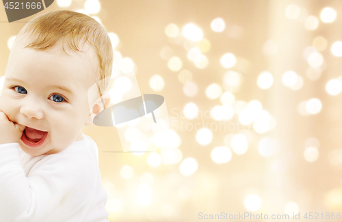 Image of close up of sweet baby over christmas lights