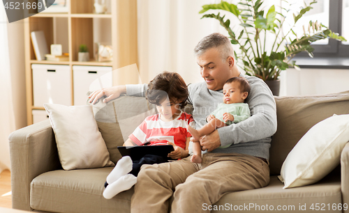 Image of happy father with preteen and baby son at home