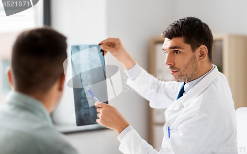 Image of doctor showing x-ray to patient at hospital