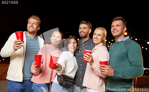 Image of friends with drinks at rooftop party