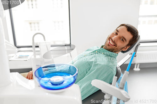 Image of happy smiling male patient at dental clinic