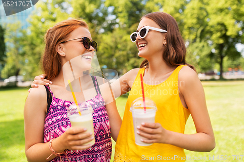 Image of teenage girls with milk shakes at summer park