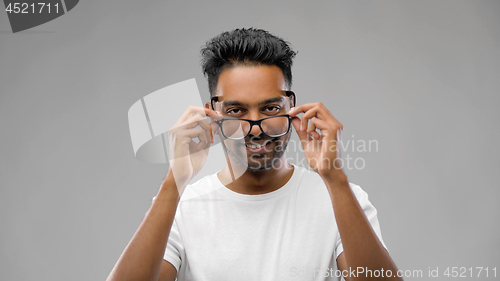 Image of happy indian man in eyeglasses or student