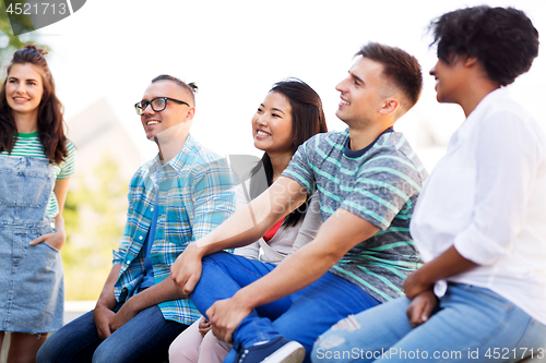 Image of happy international friends in park