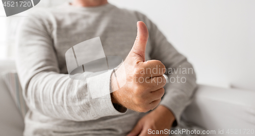 Image of close up of senior man showing thumbs up