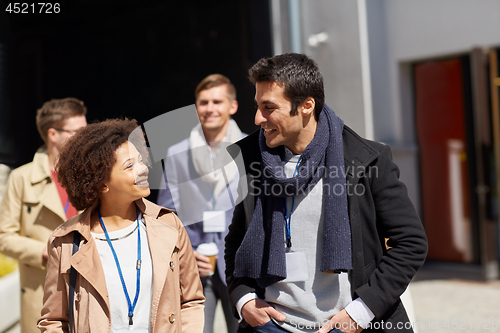 Image of business team with conference badges in city