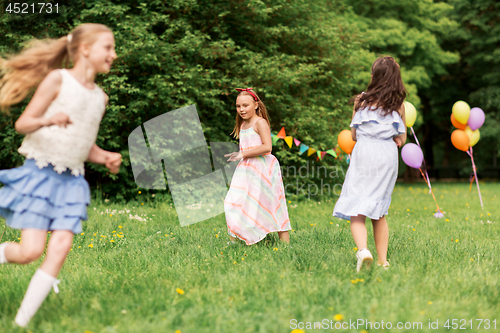 Image of happy girls playing tag game at birthday party