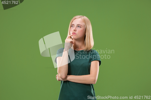 Image of Young serious thoughtful business woman. Doubt concept.