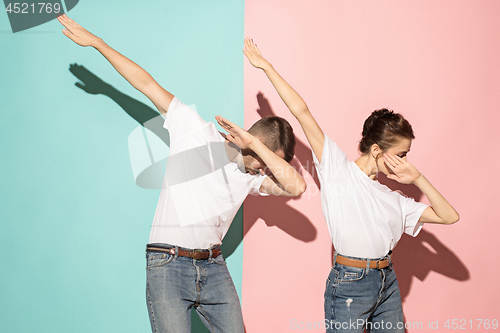 Image of A couple of young man and woman dancing hip-hop at studio.