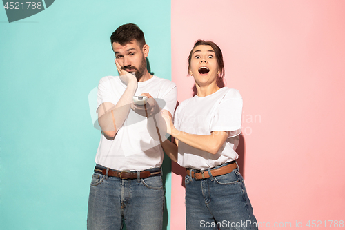 Image of Closeup portrait of young couple, man, woman. One being excited 