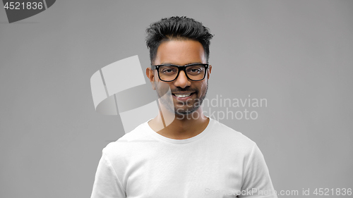 Image of happy indian man in eyeglasses or student